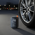 Portable Tire Inflator next to car tire at night